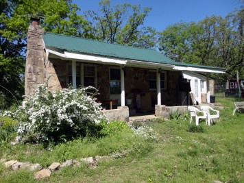 My grandma's house today. No longer owned by the family, it's been allowed to decay. She built it herself from solid stone with help from my uncles & cousins in 1940.